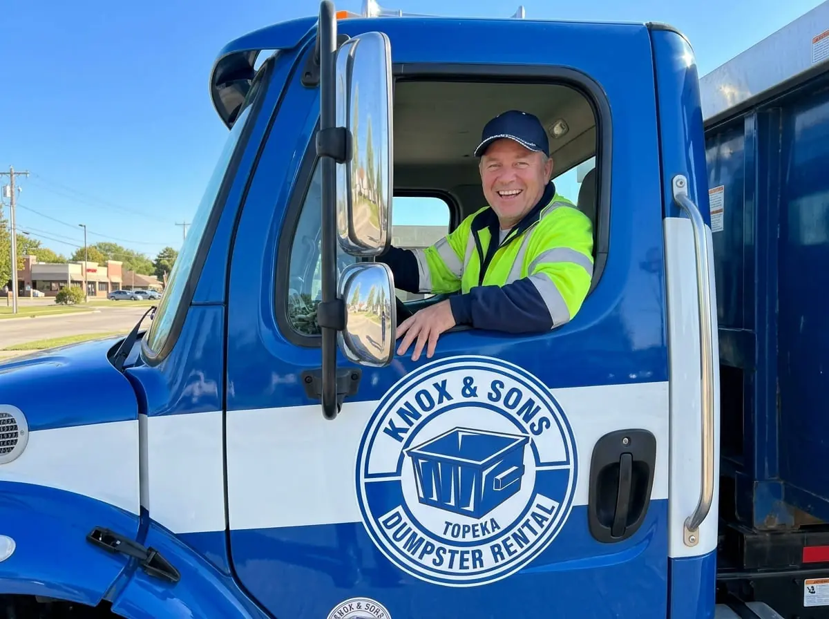 Our dumpster rental process in Topeka Knox & Sons driver in a delivery truck cab serving a Topeka, KS property